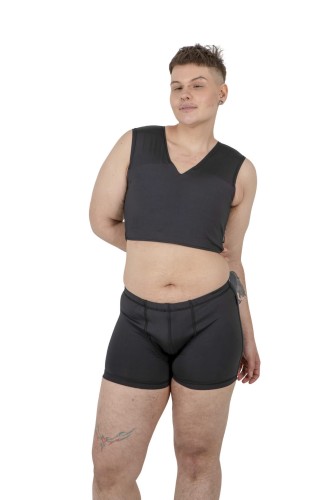 Model wearing black Packer Swim Trunks with hidden packer pocket and matching Basic Binder, front view.